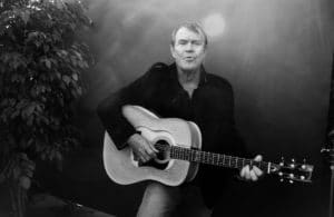 Glen Campbell performing with acoustic guitar